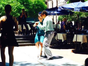 Tango dancers grace the sidewalks.