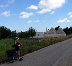 Cycling in Alberello, known for its cone-shaped Trulli houses.